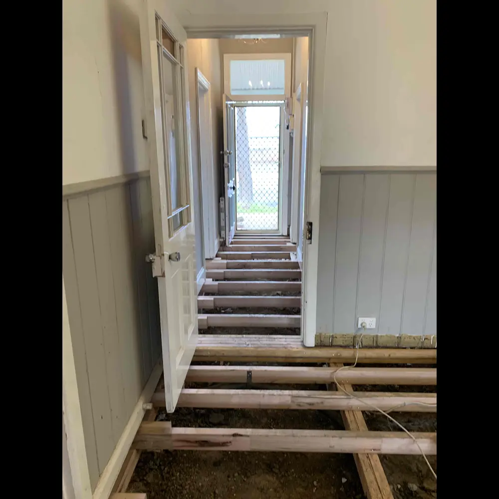 Sub-floor view of completed reblock with concrete stumps and timber bearers